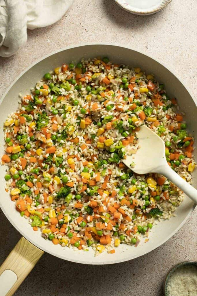 This Vegetable Risotto is rich and creamy, loaded with tender vegetables and arborio rice. It's fancy but totally approachable for weeknight dinner! | aheadofthyme.com