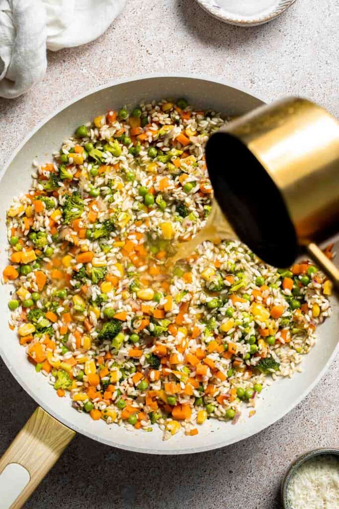 This Vegetable Risotto is rich and creamy, loaded with tender vegetables and arborio rice. It's fancy but totally approachable for weeknight dinner! | aheadofthyme.com