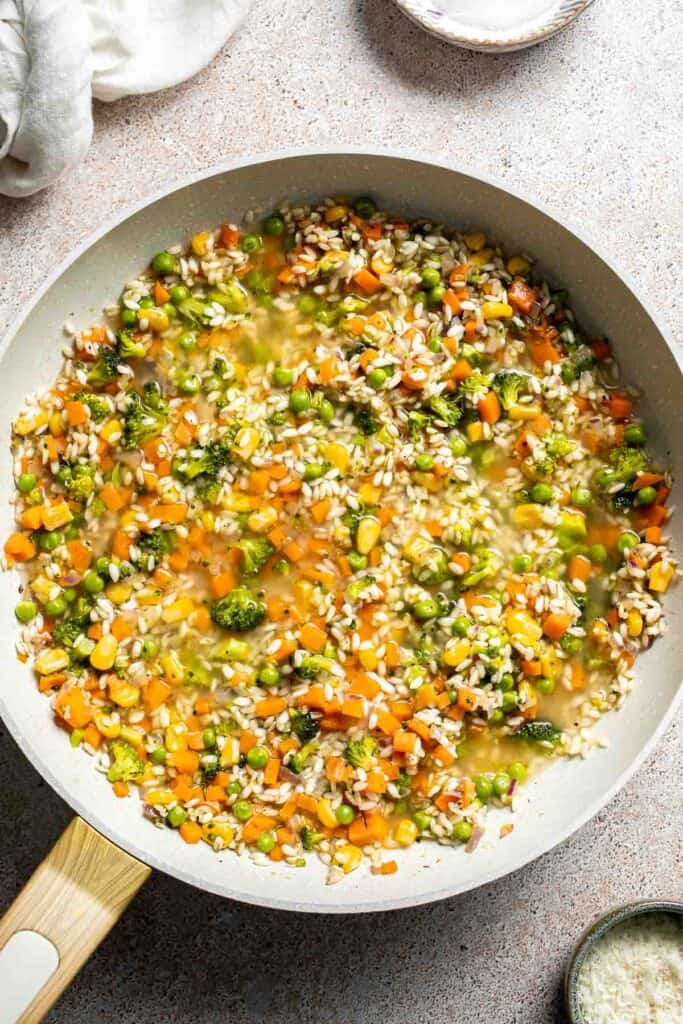 This Vegetable Risotto is rich and creamy, loaded with tender vegetables and arborio rice. It's fancy but totally approachable for weeknight dinner! | aheadofthyme.com