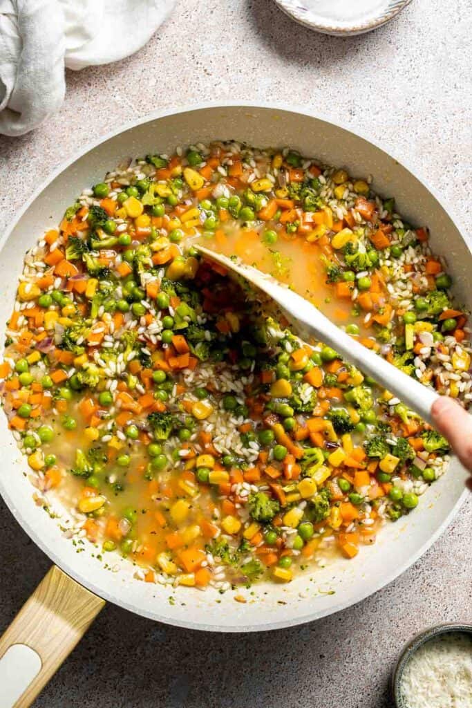 This Vegetable Risotto is rich and creamy, loaded with tender vegetables and arborio rice. It's fancy but totally approachable for weeknight dinner! | aheadofthyme.com