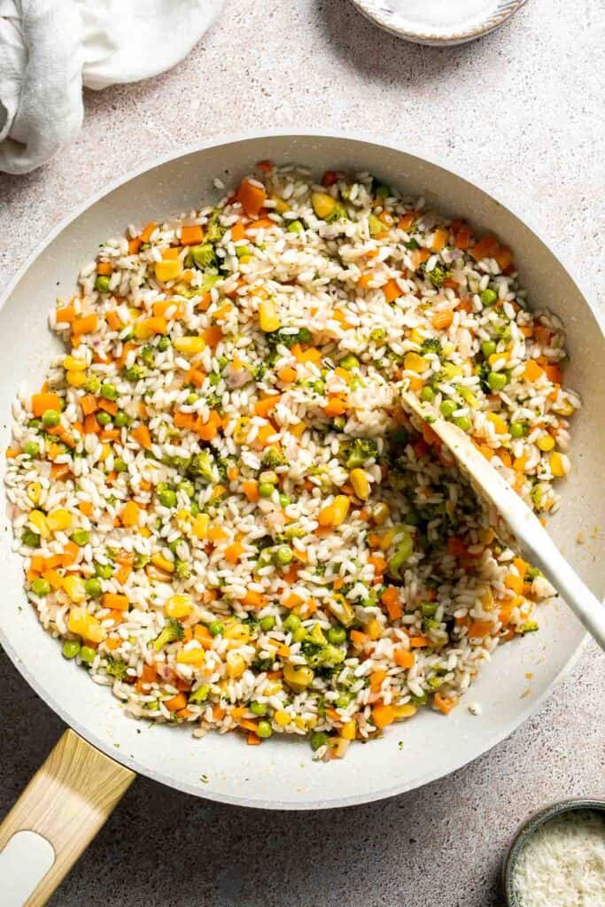 This Vegetable Risotto is rich and creamy, loaded with tender vegetables and arborio rice. It's fancy but totally approachable for weeknight dinner! | aheadofthyme.com