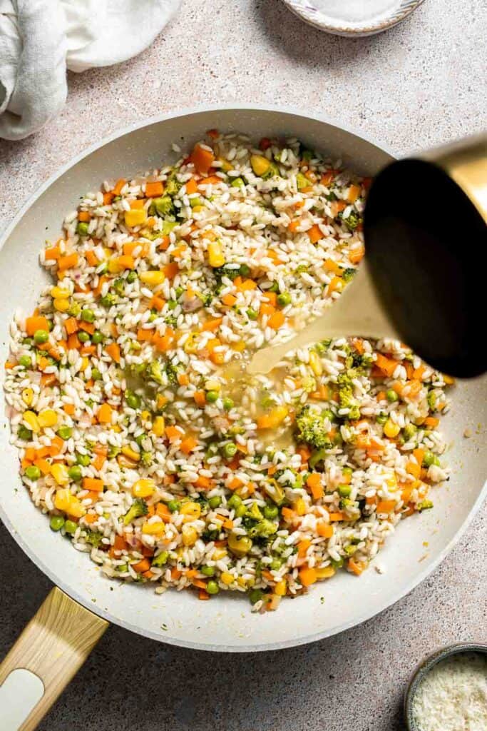This Vegetable Risotto is rich and creamy, loaded with tender vegetables and arborio rice. It's fancy but totally approachable for weeknight dinner! | aheadofthyme.com