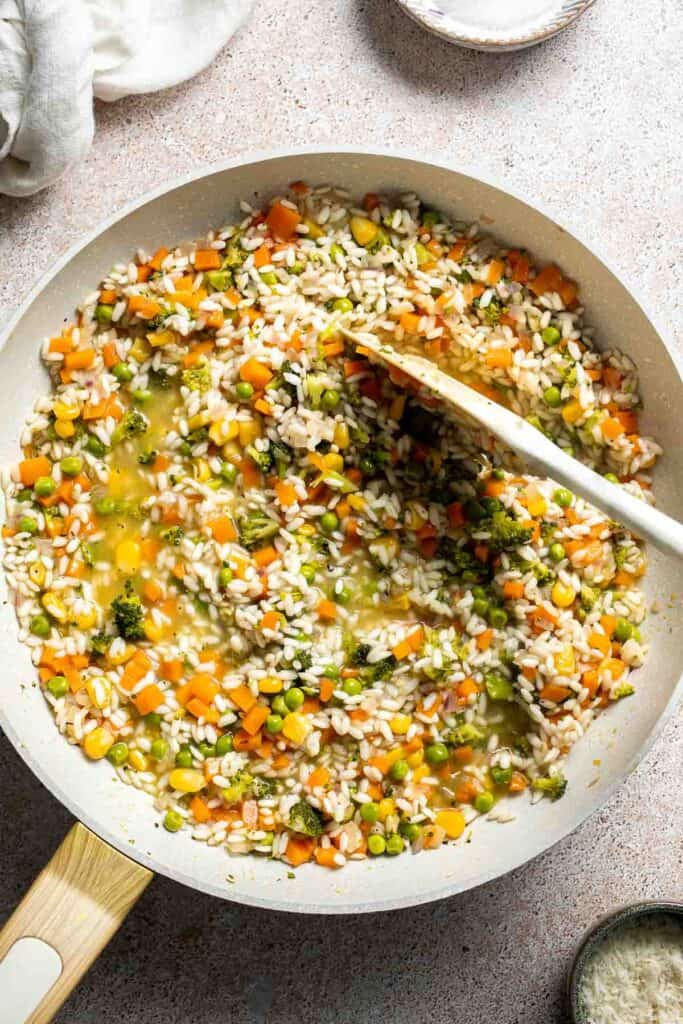 This Vegetable Risotto is rich and creamy, loaded with tender vegetables and arborio rice. It's fancy but totally approachable for weeknight dinner! | aheadofthyme.com