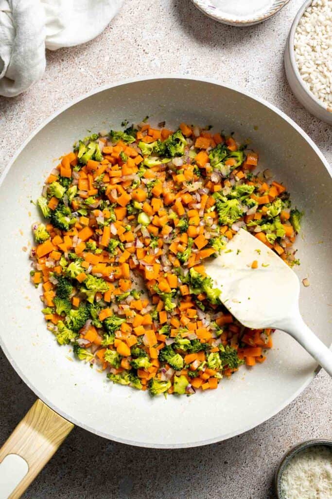 This Vegetable Risotto is rich and creamy, loaded with tender vegetables and arborio rice. It's fancy but totally approachable for weeknight dinner! | aheadofthyme.com