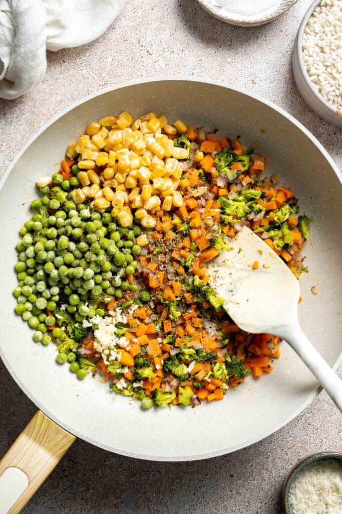 This Vegetable Risotto is rich and creamy, loaded with tender vegetables and arborio rice. It's fancy but totally approachable for weeknight dinner! | aheadofthyme.com