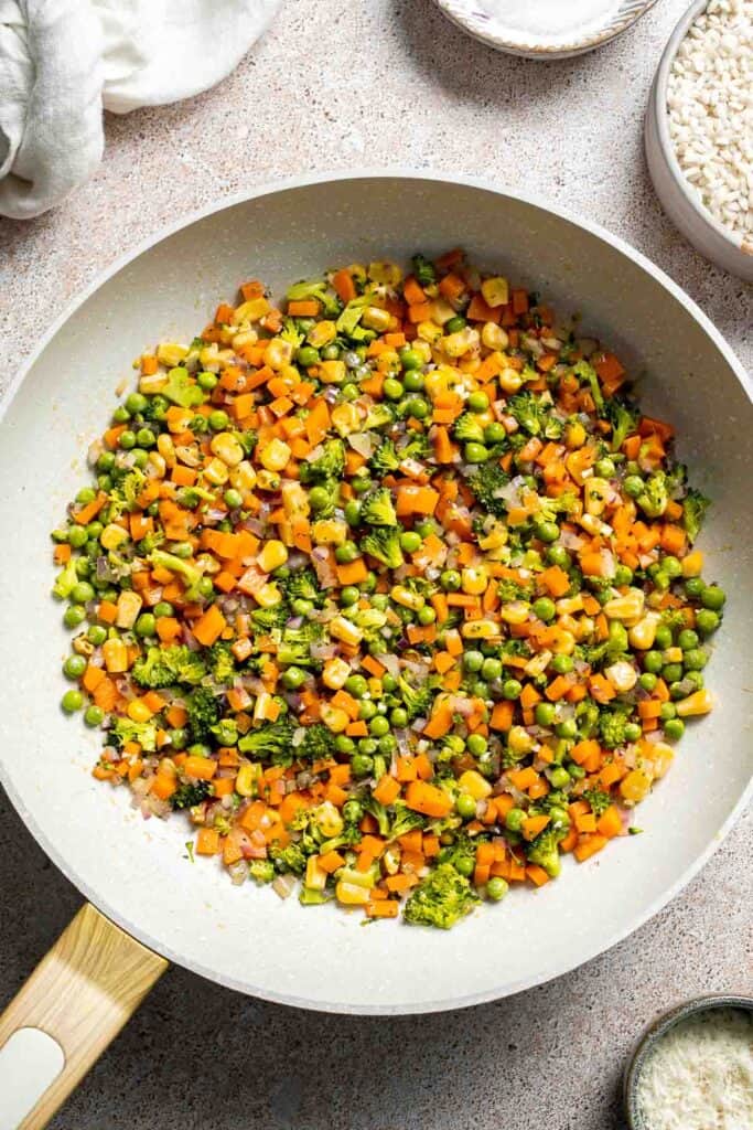 This Vegetable Risotto is rich and creamy, loaded with tender vegetables and arborio rice. It's fancy but totally approachable for weeknight dinner! | aheadofthyme.com