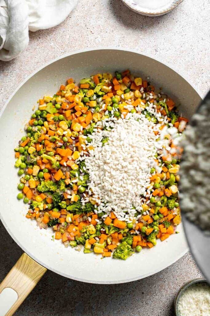 This Vegetable Risotto is rich and creamy, loaded with tender vegetables and arborio rice. It's fancy but totally approachable for weeknight dinner! | aheadofthyme.com