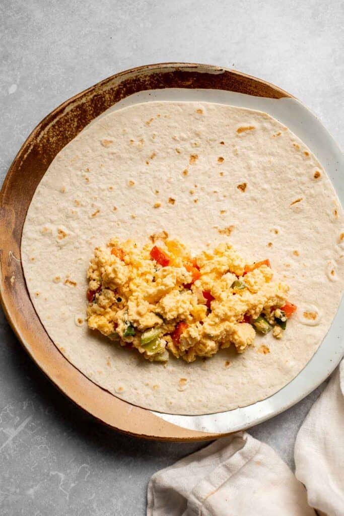 Vegetarian Breakfast Burritos are packed with crispy potatoes, veggies, fluffy eggs, cheese, and avocado. A balanced breakfast that actually keeps you full! | aheadofthyme.com