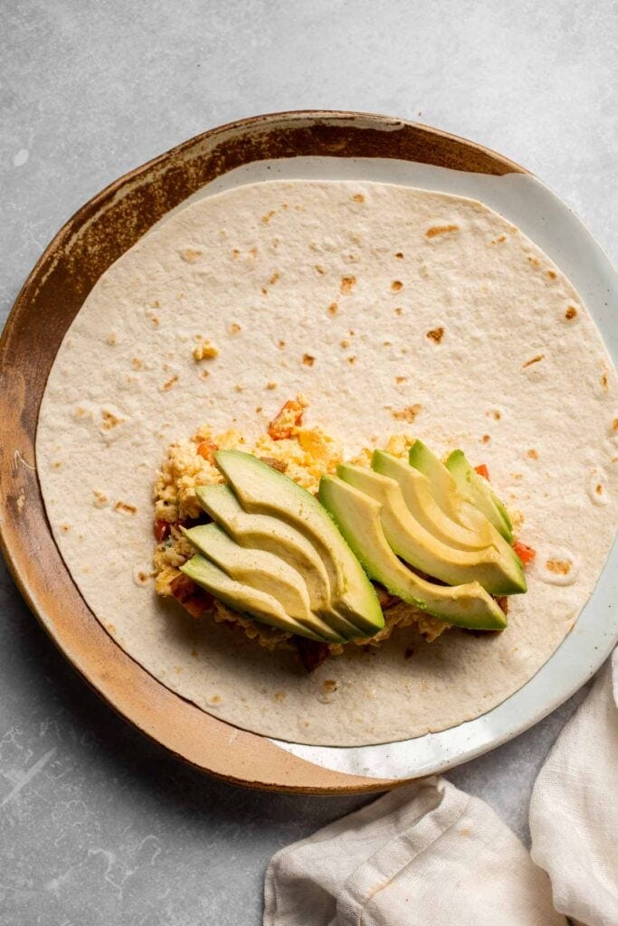 Vegetarian Breakfast Burritos are packed with crispy potatoes, veggies, fluffy eggs, cheese, and avocado. A balanced breakfast that actually keeps you full! | aheadofthyme.com