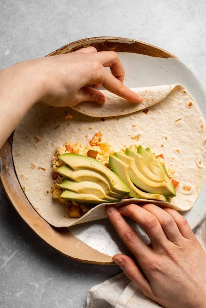 Vegetarian Breakfast Burritos are packed with crispy potatoes, veggies, fluffy eggs, cheese, and avocado. A balanced breakfast that actually keeps you full! | aheadofthyme.com