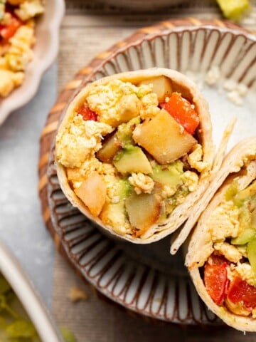 Vegetarian Breakfast Burritos are packed with crispy potatoes, veggies, fluffy eggs, cheese, and avocado. A balanced breakfast that actually keeps you full! | aheadofthyme.com