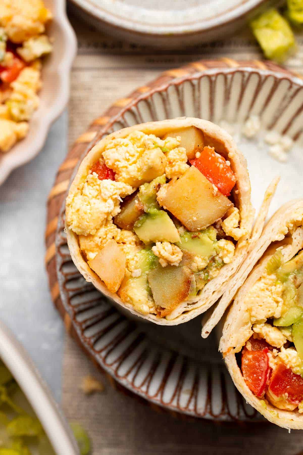 Vegetarian Breakfast Burritos are packed with crispy potatoes, veggies, fluffy eggs, cheese, and avocado. A balanced breakfast that actually keeps you full! | aheadofthyme.com