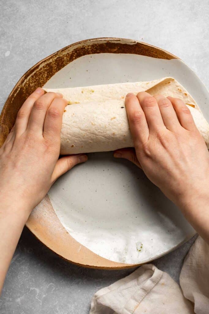 Vegetarian Breakfast Burritos are packed with crispy potatoes, veggies, fluffy eggs, cheese, and avocado. A balanced breakfast that actually keeps you full! | aheadofthyme.com