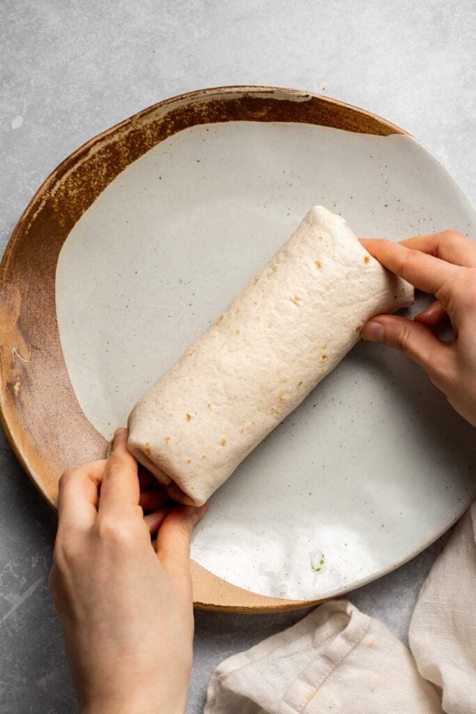 Vegetarian Breakfast Burritos are packed with crispy potatoes, veggies, fluffy eggs, cheese, and avocado. A balanced breakfast that actually keeps you full! | aheadofthyme.com
