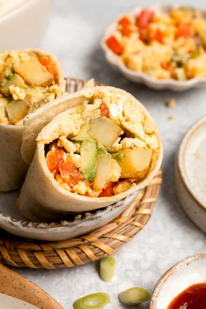 Vegetarian Breakfast Burritos are packed with crispy potatoes, veggies, fluffy eggs, cheese, and avocado. A balanced breakfast that actually keeps you full! | aheadofthyme.com