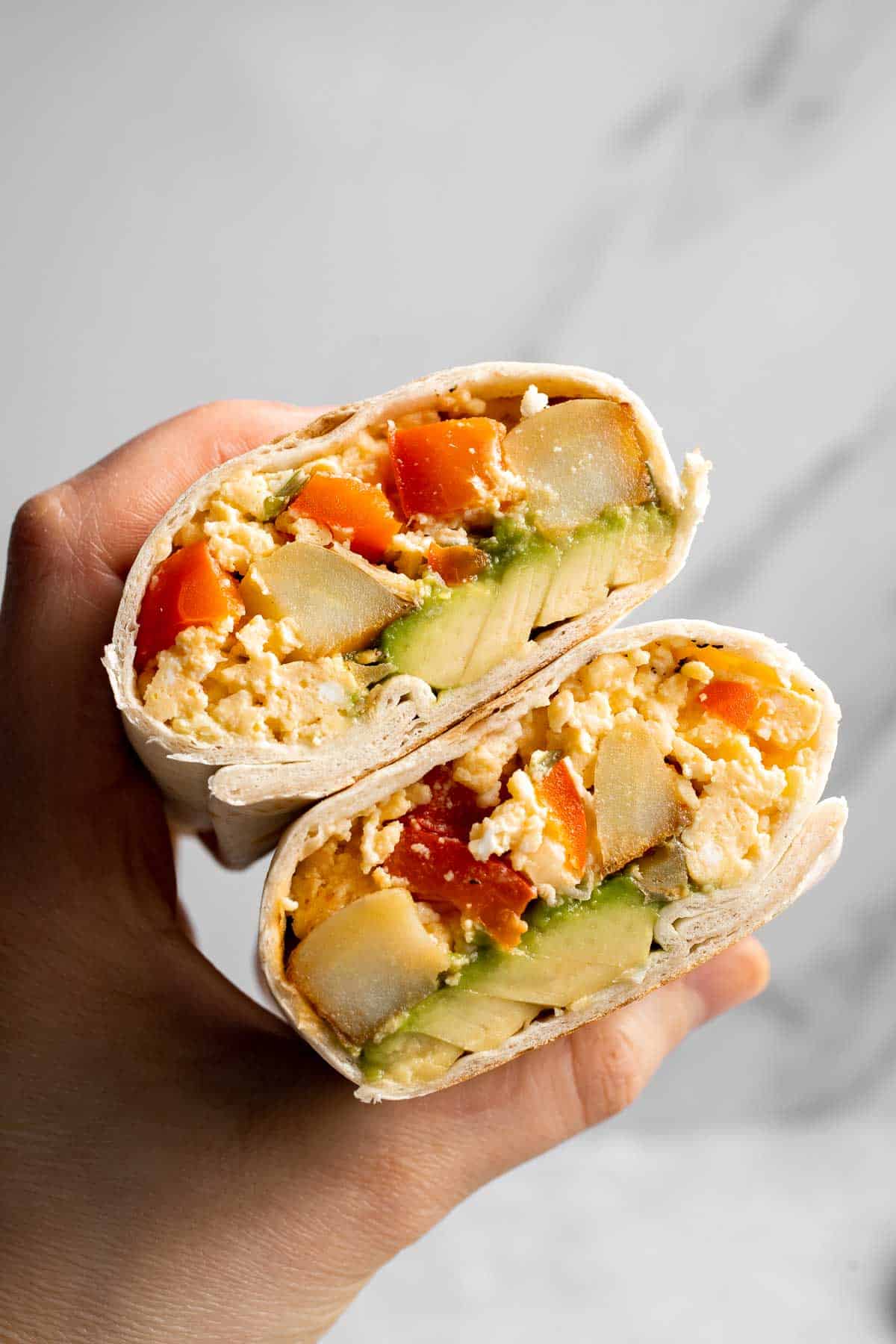 Vegetarian Breakfast Burritos are packed with crispy potatoes, veggies, fluffy eggs, cheese, and avocado. A balanced breakfast that actually keeps you full! | aheadofthyme.com