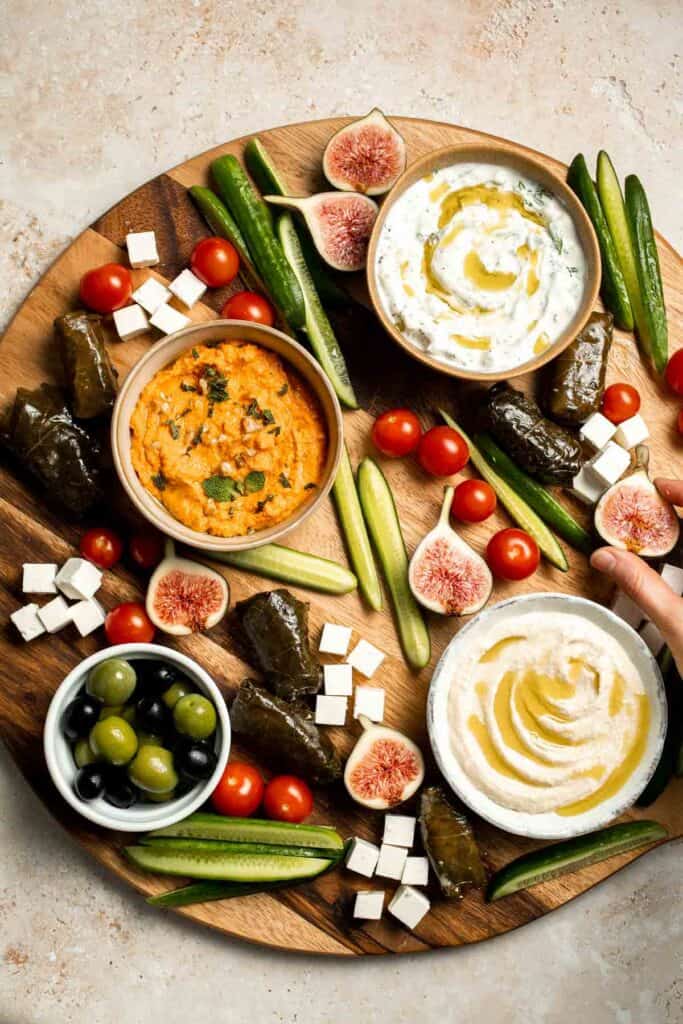 This easy Mezze Platter brings the best of Mediterranean snacking straight to your table with a colorful mix of dips, crisp vegetables, and briny bites. | aheadofthyme.com