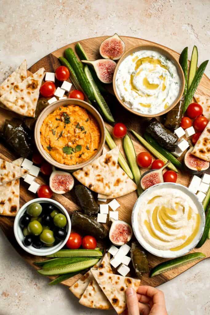 This easy Mezze Platter brings the best of Mediterranean snacking straight to your table with a colorful mix of dips, crisp vegetables, and briny bites. | aheadofthyme.com