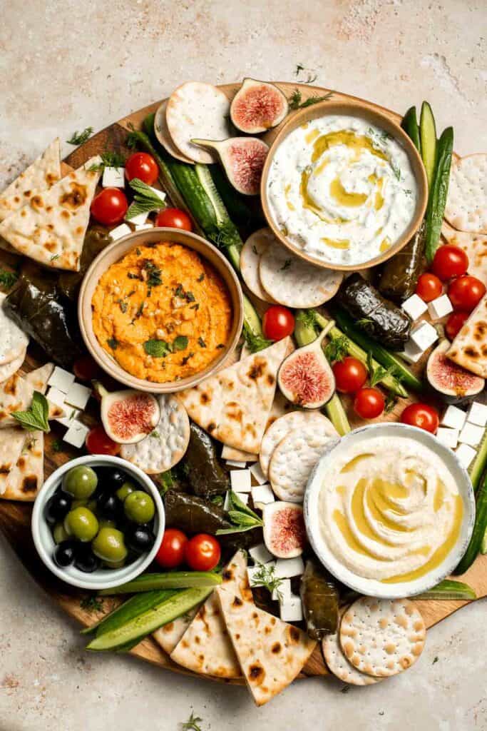 This easy Mezze Platter brings the best of Mediterranean snacking straight to your table with a colorful mix of dips, crisp vegetables, and briny bites. | aheadofthyme.com