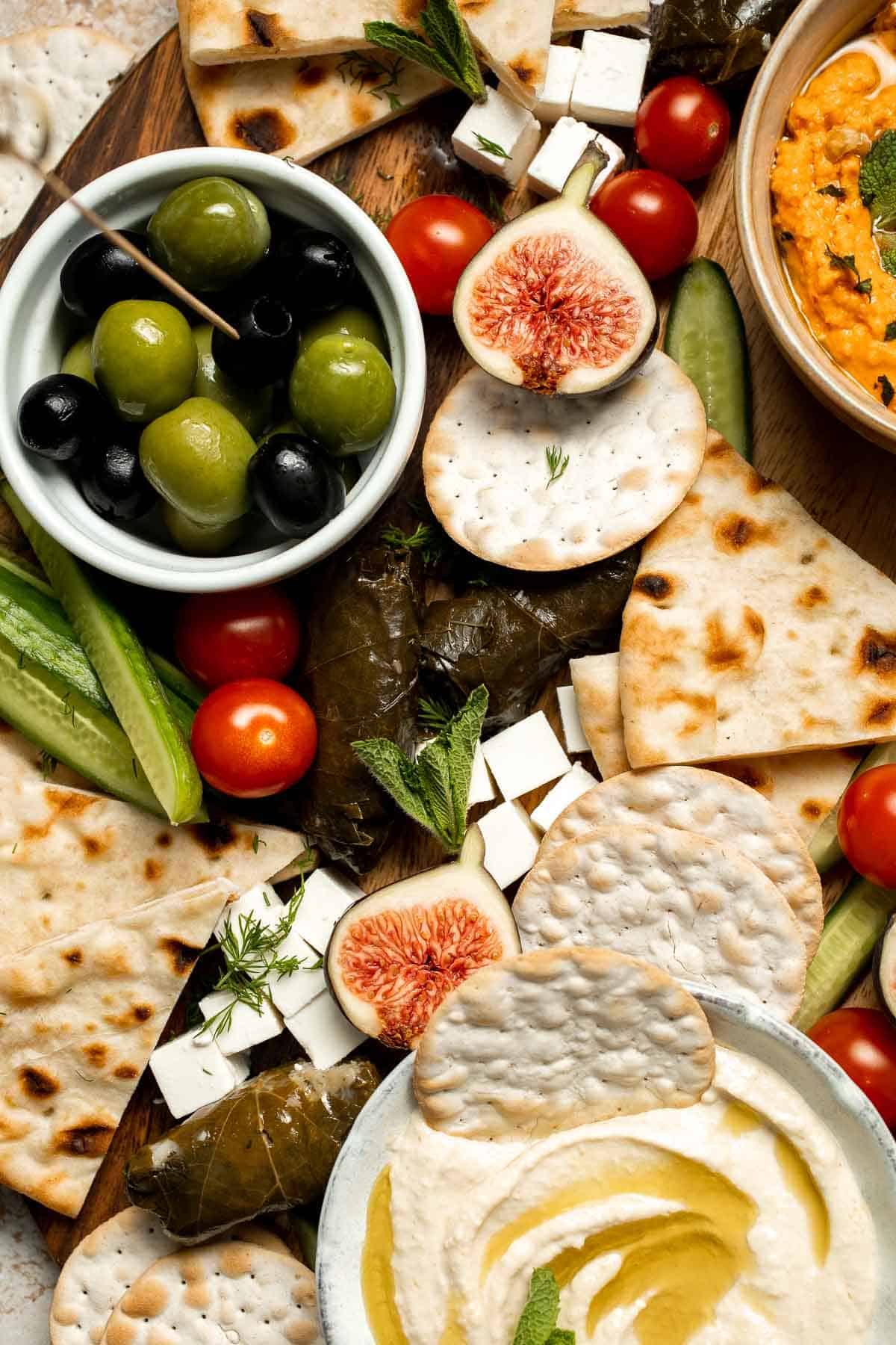 This easy Mezze Platter brings the best of Mediterranean snacking straight to your table with a colorful mix of dips, crisp vegetables, and briny bites. | aheadofthyme.com