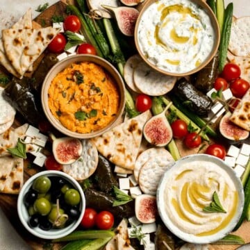 This easy Mezze Platter brings the best of Mediterranean snacking straight to your table with a colorful mix of dips, crisp vegetables, and briny bites. | aheadofthyme.com
