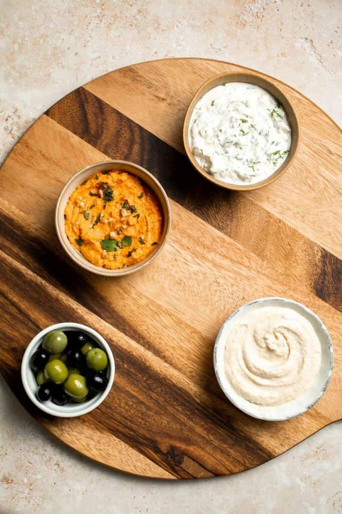 This easy Mezze Platter brings the best of Mediterranean snacking straight to your table with a colorful mix of dips, crisp vegetables, and briny bites. | aheadofthyme.com