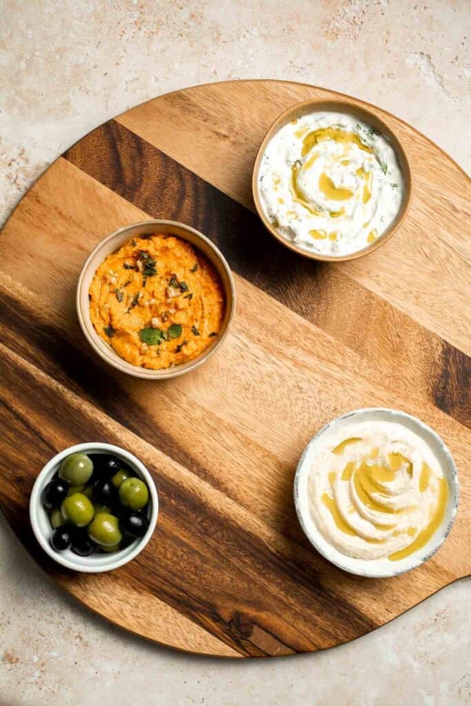 This easy Mezze Platter brings the best of Mediterranean snacking straight to your table with a colorful mix of dips, crisp vegetables, and briny bites. | aheadofthyme.com
