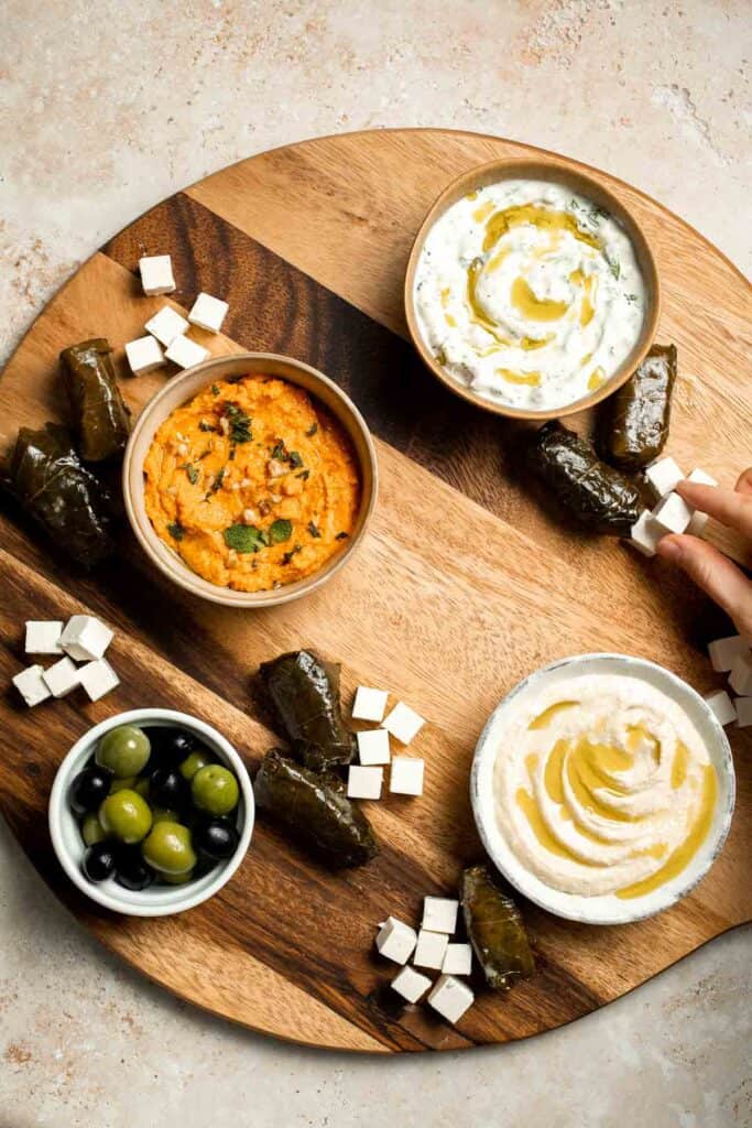 This easy Mezze Platter brings the best of Mediterranean snacking straight to your table with a colorful mix of dips, crisp vegetables, and briny bites. | aheadofthyme.com