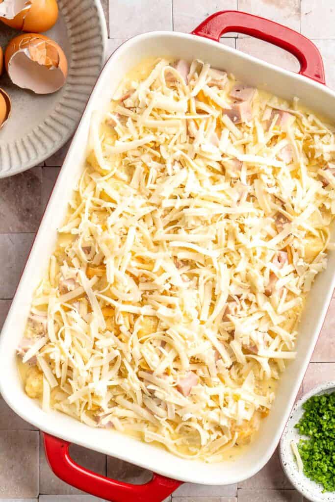 This Tater Tot Breakfast Casserole features a savory base of fluffy eggs, melty cheese, and ham, with golden, crispy tater tots that bakes to perfection. | aheadofthyme.com