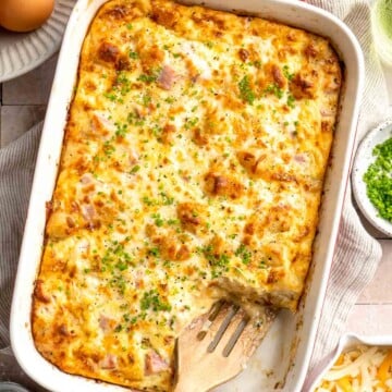 This Tater Tot Breakfast Casserole features a savory base of fluffy eggs, melty cheese, and ham, with golden, crispy tater tots that bakes to perfection. | aheadofthyme.com