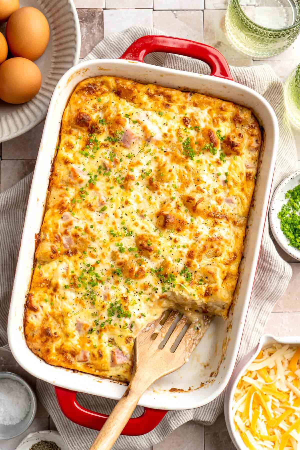 This Tater Tot Breakfast Casserole features a savory base of fluffy eggs, melty cheese, and ham, with golden, crispy tater tots that bakes to perfection. | aheadofthyme.com