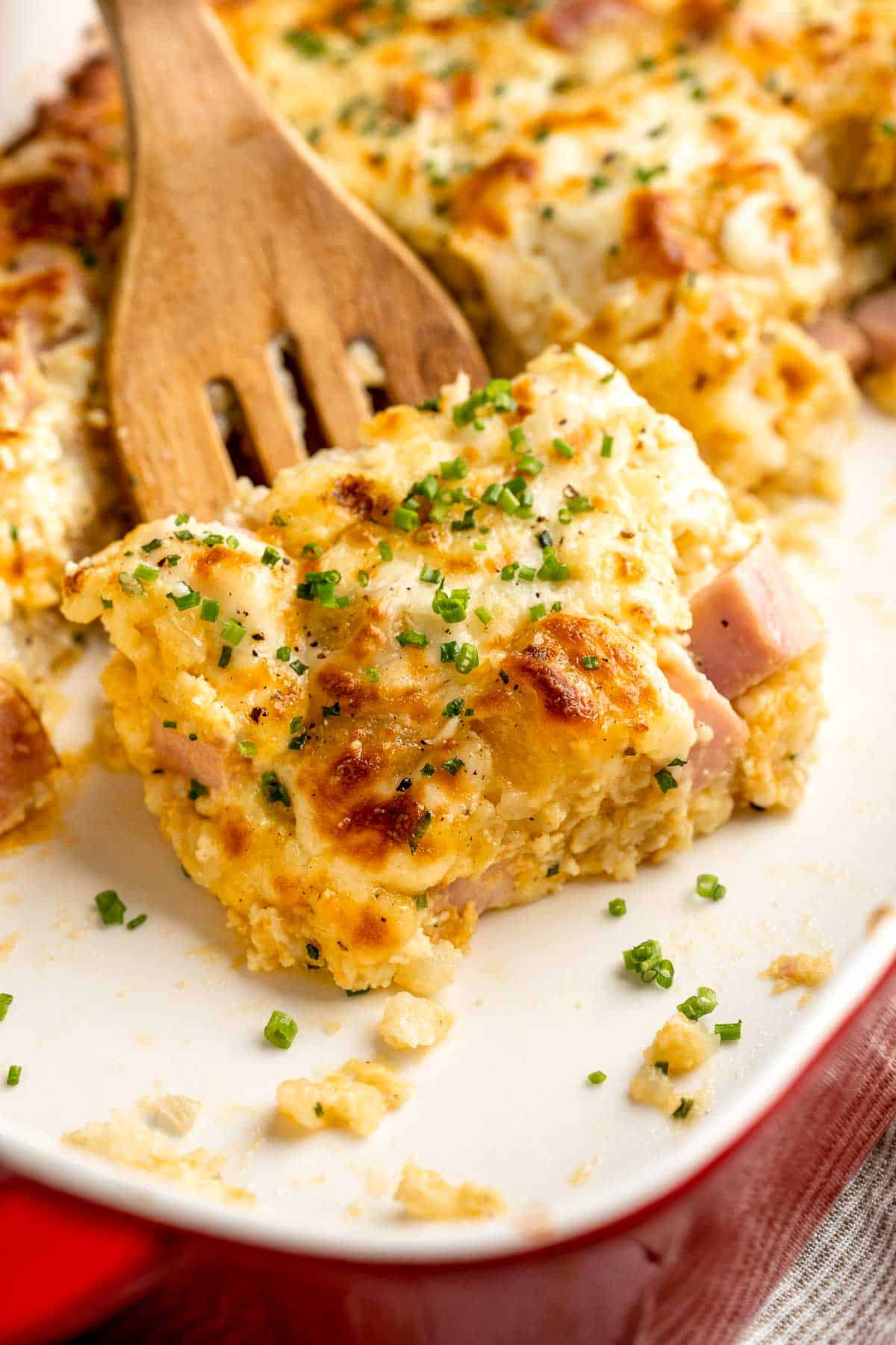 This Tater Tot Breakfast Casserole features a savory base of fluffy eggs, melty cheese, and ham, with golden, crispy tater tots that bakes to perfection. | aheadofthyme.com