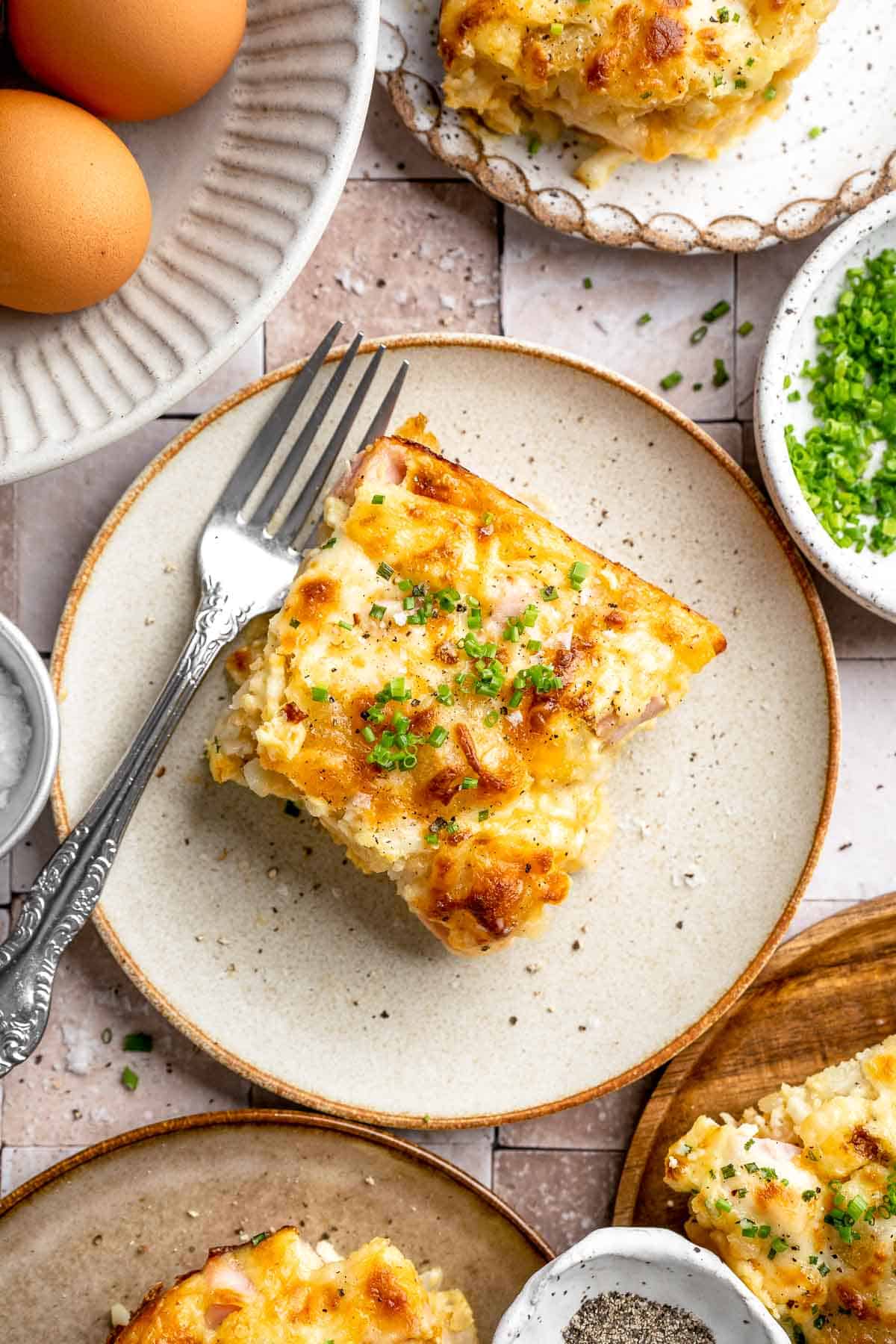 This Tater Tot Breakfast Casserole features a savory base of fluffy eggs, melty cheese, and ham, with golden, crispy tater tots that bakes to perfection. | aheadofthyme.com