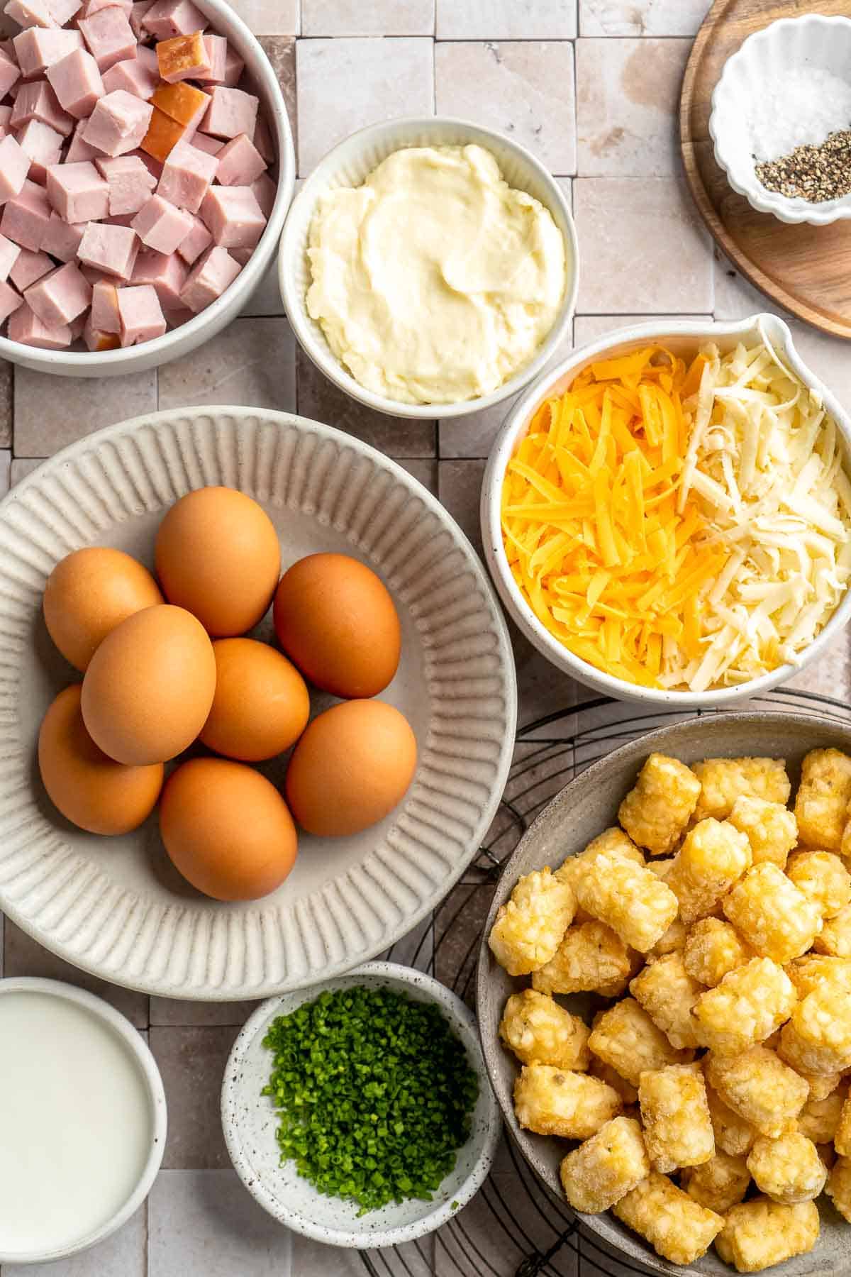 This Tater Tot Breakfast Casserole features a savory base of fluffy eggs, melty cheese, and ham, with golden, crispy tater tots that bakes to perfection. | aheadofthyme.com