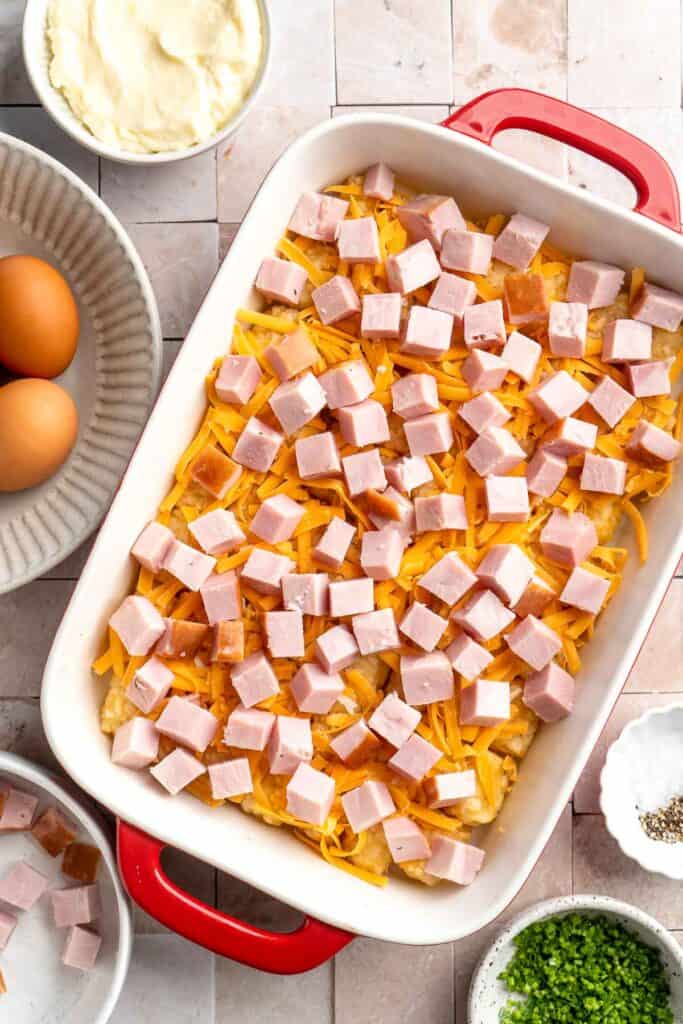 This Tater Tot Breakfast Casserole features a savory base of fluffy eggs, melty cheese, and ham, with golden, crispy tater tots that bakes to perfection. | aheadofthyme.com