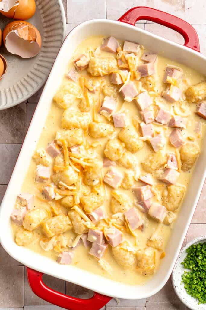 This Tater Tot Breakfast Casserole features a savory base of fluffy eggs, melty cheese, and ham, with golden, crispy tater tots that bakes to perfection. | aheadofthyme.com