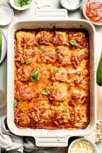 Baked Zucchini Roll Ups are a low carb lasagna alternative with ricotta, marinara, and cheese rolled in tender zucchini slices. It's healthier and lighter! | aheadofthyme.com