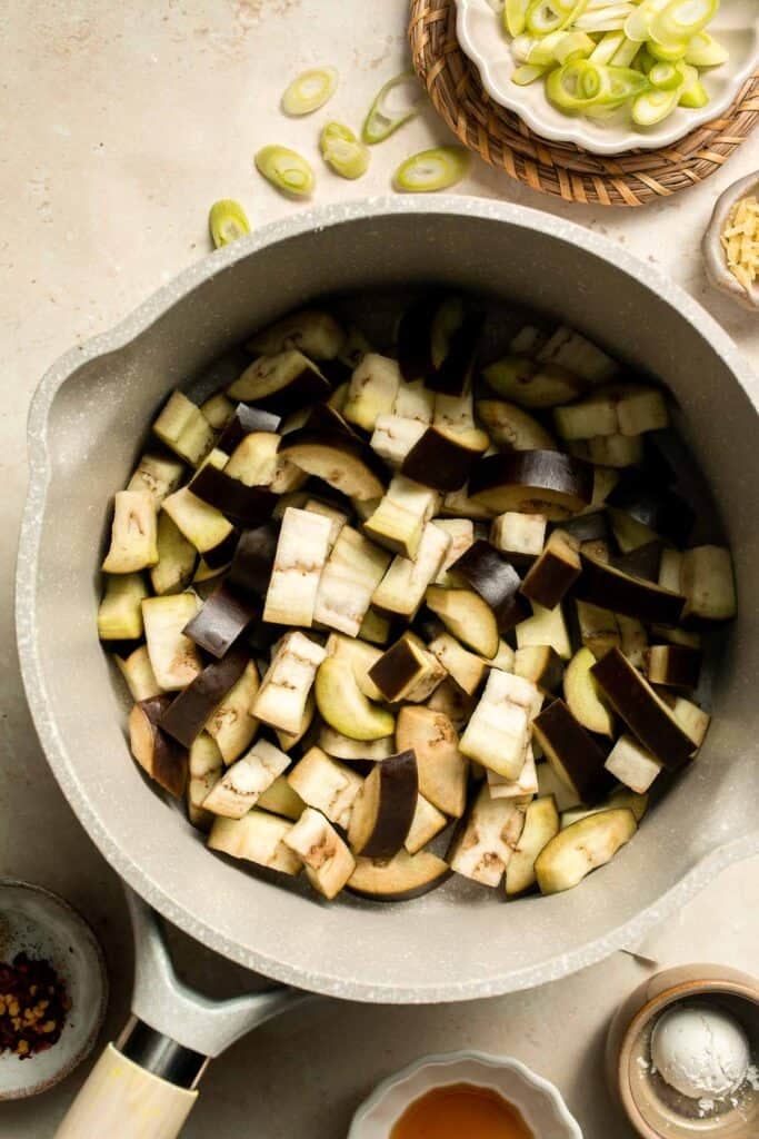 Quick and flavorful, this Chinese Eggplant Stir Fry is packed with garlic, ginger, and savory sauce. Perfect for rice or noodles! | aheadofthyme.com