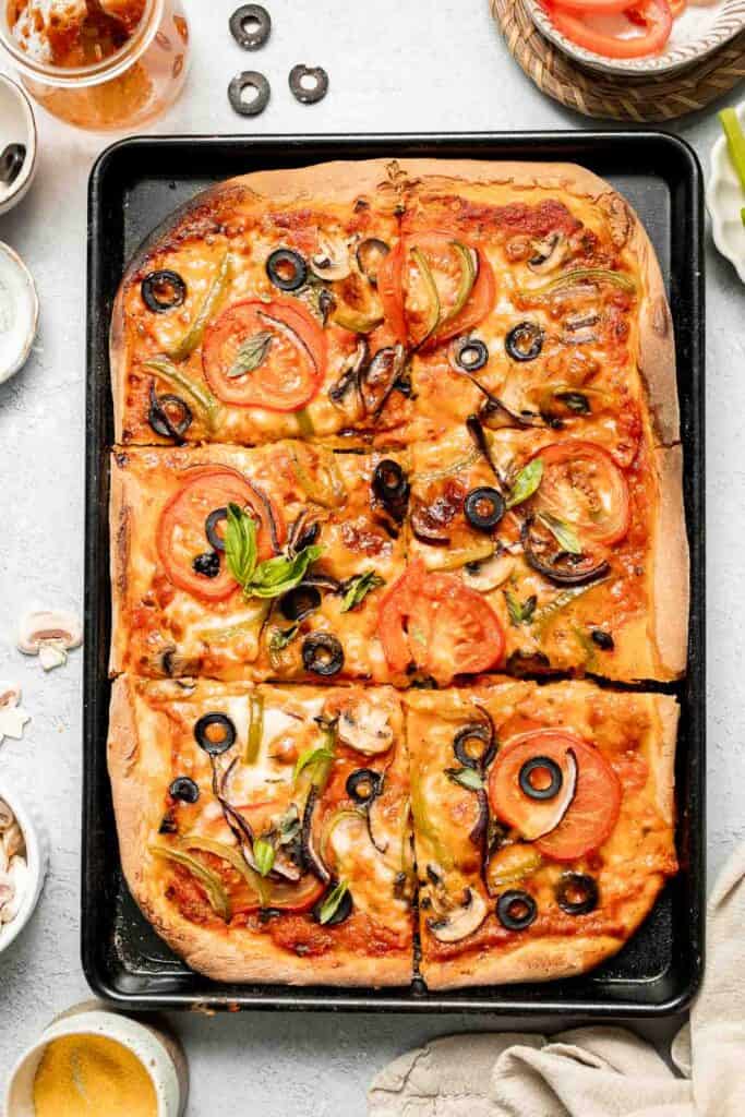 This Easy Sheet Pan Pizza recipe is perfect for a quick weeknight dinner. With its crispy crust and customizable toppings, it'll become a family favorite! | aheadofthyme.com