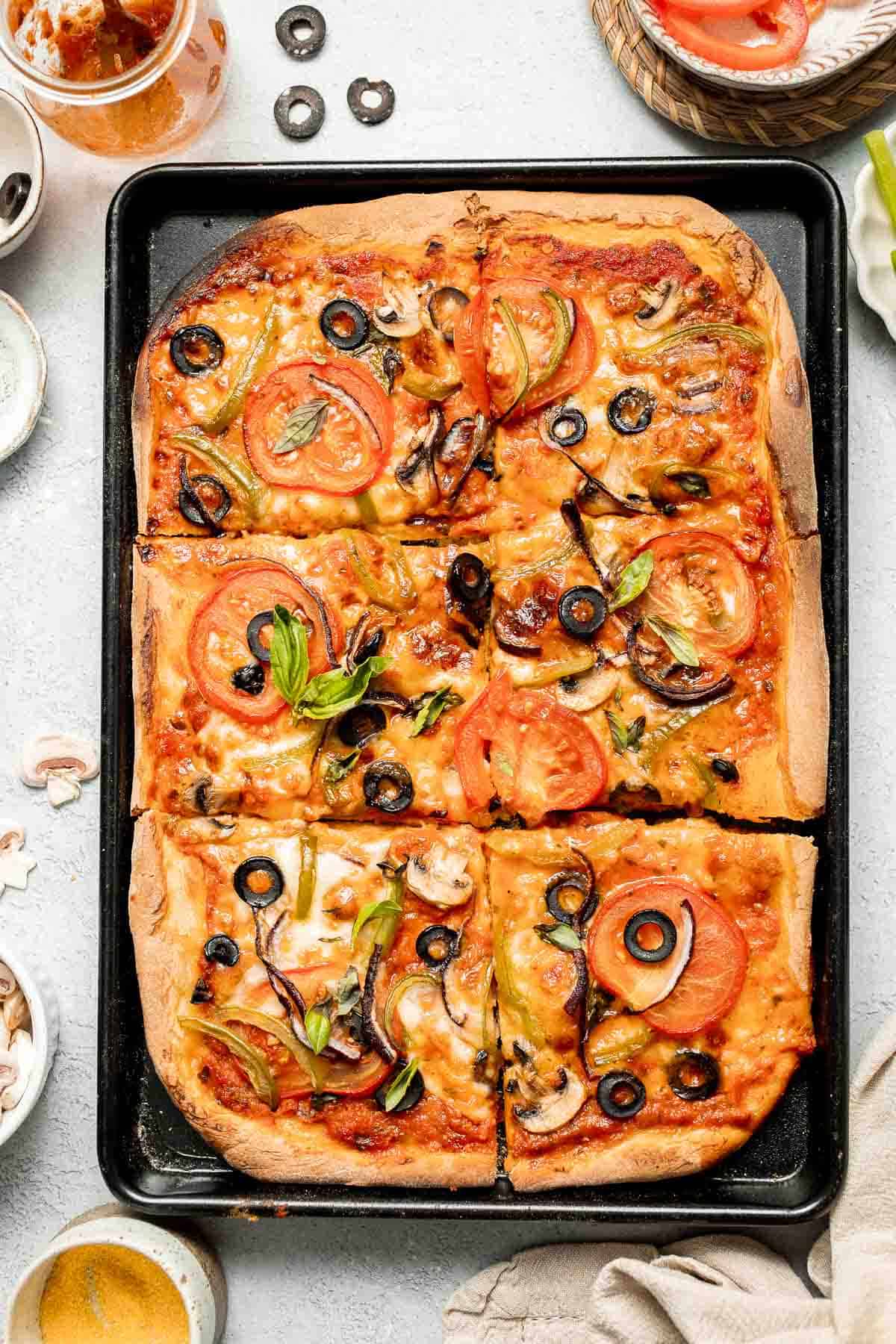 This Easy Sheet Pan Pizza recipe is perfect for a quick weeknight dinner. With its crispy crust and customizable toppings, it'll become a family favorite! | aheadofthyme.com