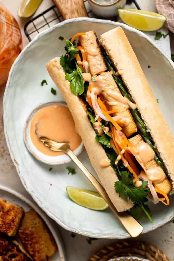 This flavorful Vegetarian Banh Mi Sandwich is made with crispy tofu, pickled vegetables, and sweet mayo layered inside a crusty baguette. | aheadofthyme.com