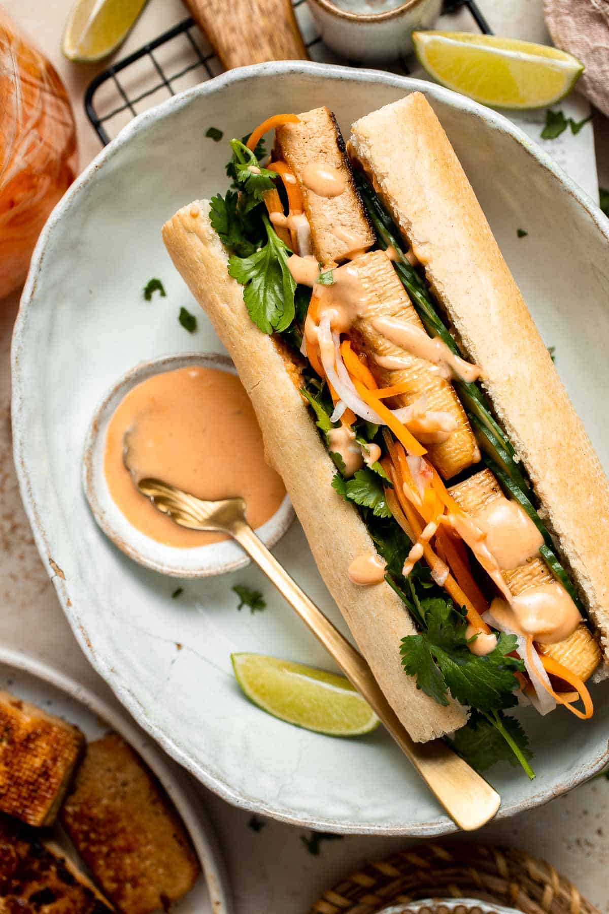 This flavorful Vegetarian Banh Mi Sandwich is made with crispy tofu, pickled vegetables, and sweet mayo layered inside a crusty baguette. | aheadofthyme.com