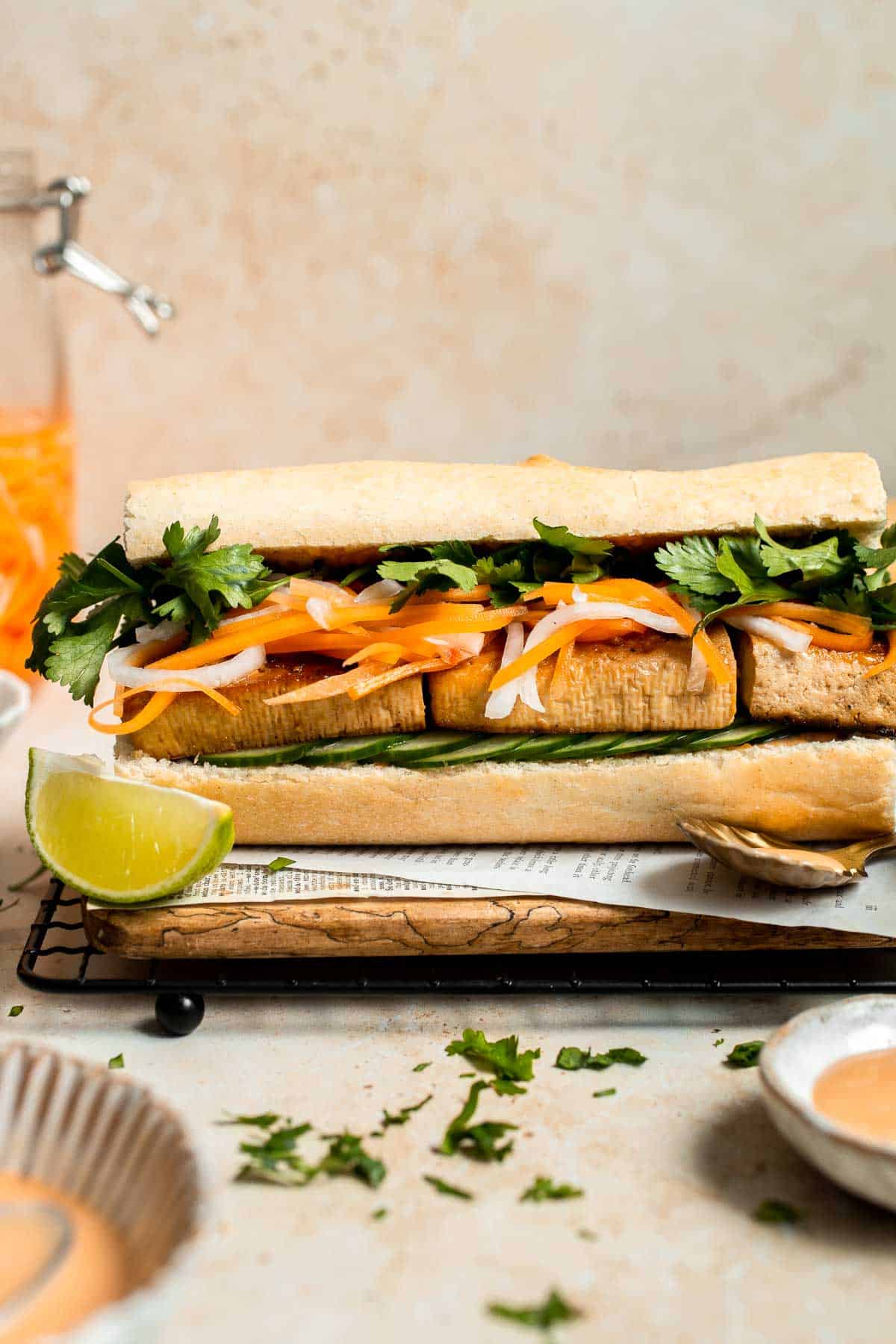 This flavorful Vegetarian Banh Mi Sandwich is made with crispy tofu, pickled vegetables, and sweet mayo layered inside a crusty baguette. | aheadofthyme.com