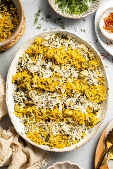 Baghali Polo is a traditional Persian dish made with fragrant basmati rice, dill, and tender fava beans. Learn how to make it with our easy recipe. | aheadofthyme.com