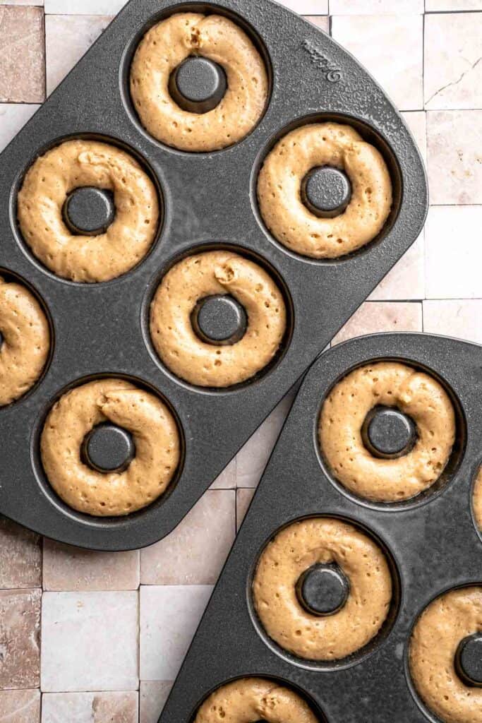 Indulge in the flavors of fall with these delicious baked apple cider donuts coated in spiced cinnamon sugar. An easy to make and cozy fall treat! | aheadofthyme.com