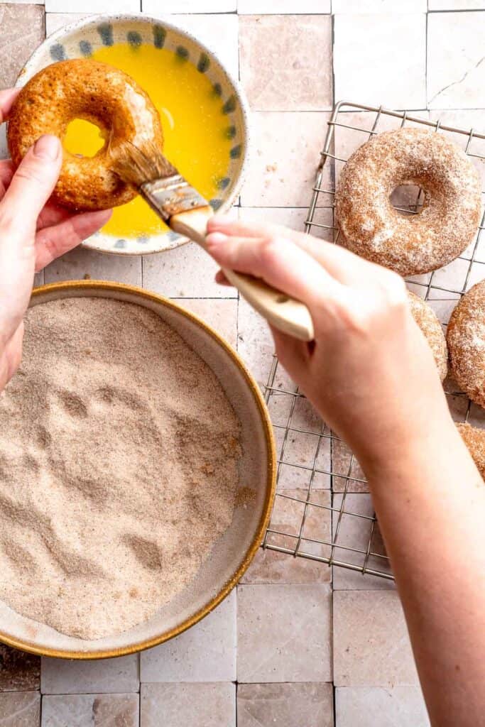Indulge in the flavors of fall with these delicious baked apple cider donuts coated in spiced cinnamon sugar. An easy to make and cozy fall treat! | aheadofthyme.com