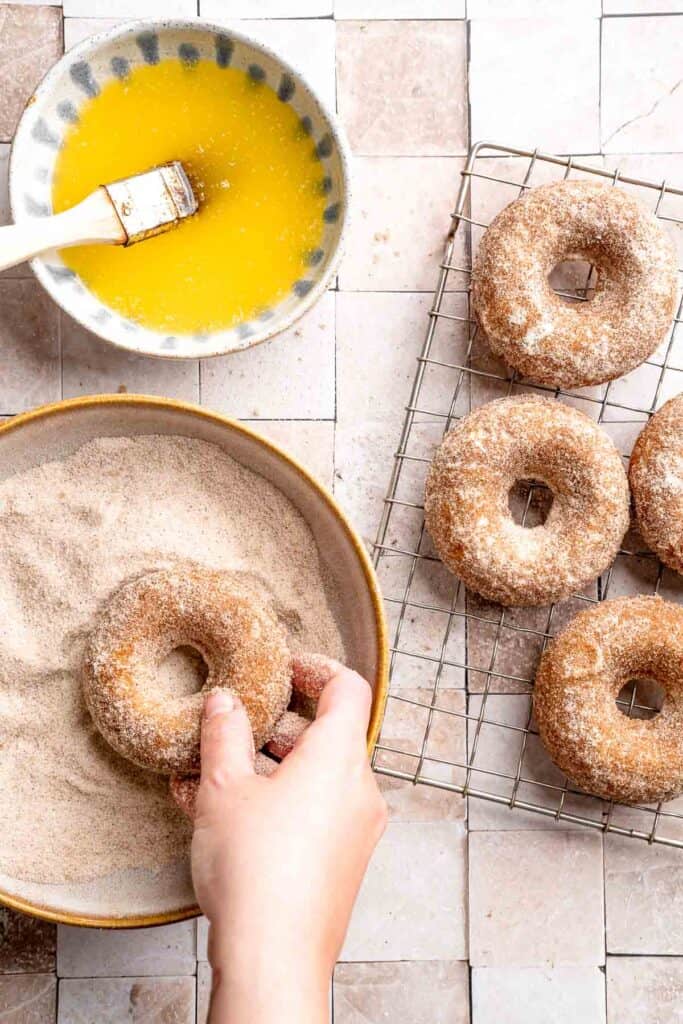 Indulge in the flavors of fall with these delicious baked apple cider donuts coated in spiced cinnamon sugar. An easy to make and cozy fall treat! | aheadofthyme.com