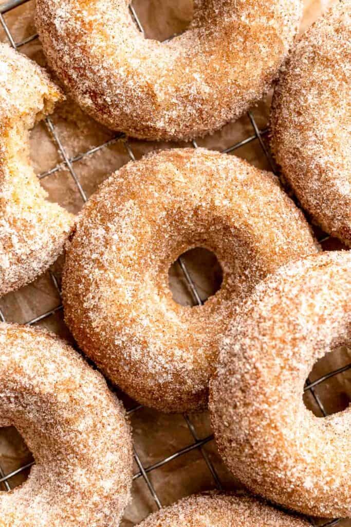 Indulge in the flavors of fall with these delicious baked apple cider donuts coated in spiced cinnamon sugar. An easy to make and cozy fall treat! | aheadofthyme.com