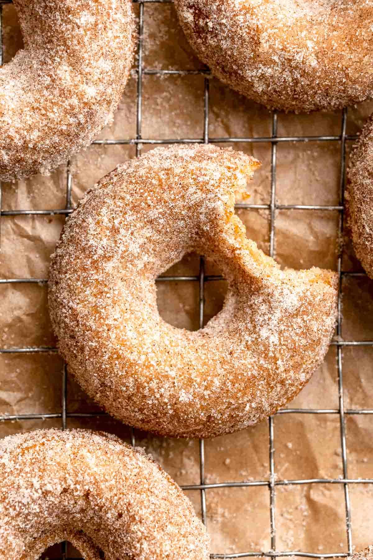 Indulge in the flavors of fall with these delicious baked apple cider donuts coated in spiced cinnamon sugar. An easy to make and cozy fall treat! | aheadofthyme.com