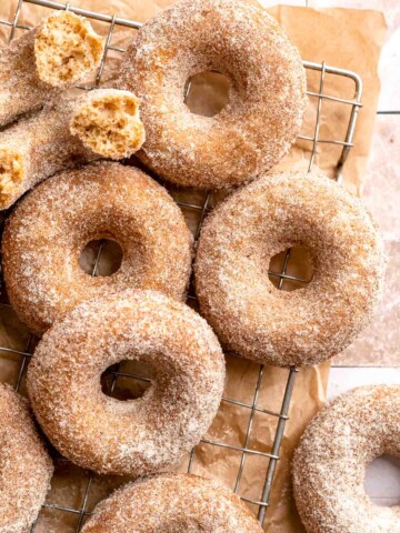 Indulge in the flavors of fall with these delicious baked apple cider donuts coated in spiced cinnamon sugar. An easy to make and cozy fall treat! | aheadofthyme.com